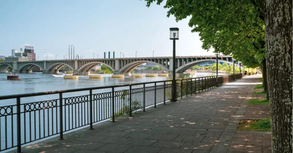 View of the West River Parkway along the Mississippi River in Minneapolis, with a bridge in the background.