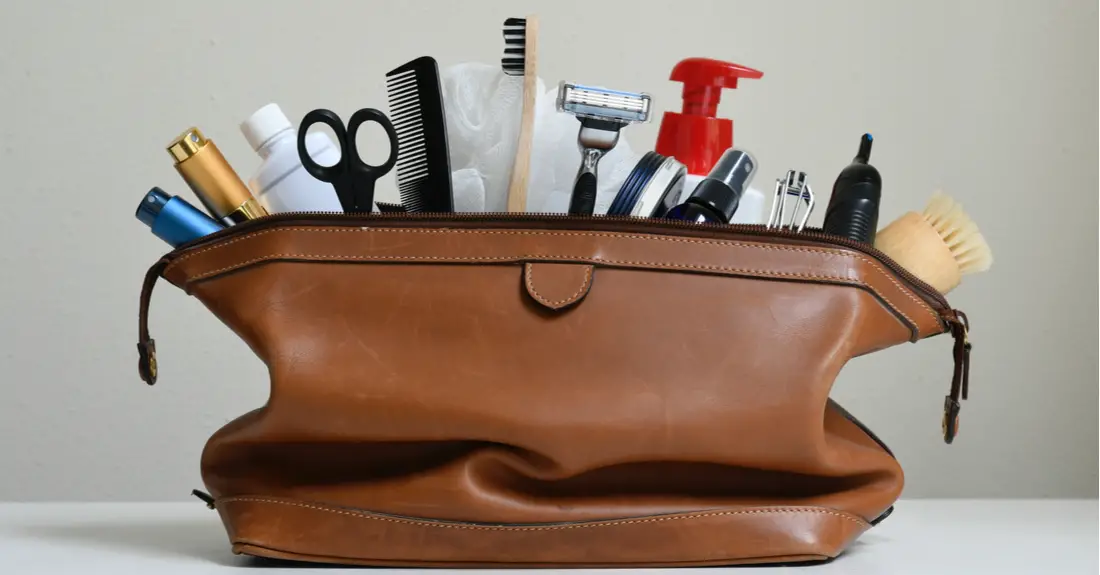 A fully packed toiletry kit with a comb, toothbrush, razor and other items.